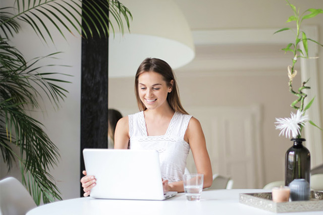 femme souriante devant son ordinateur